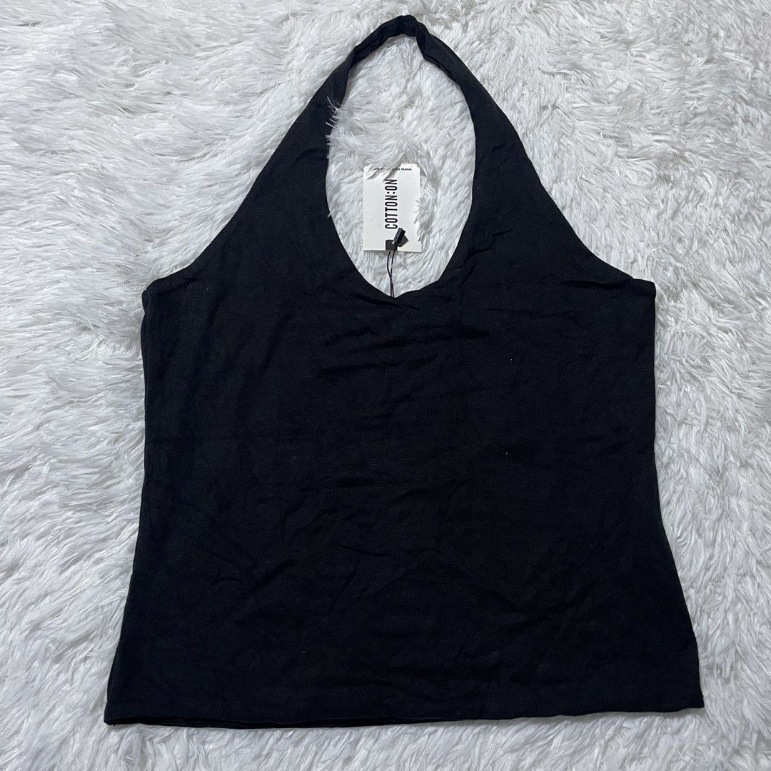 Cotton On Black Halter Top (Category: Sleeveless) located in Batangas. Submitted by strwsherry (Listing ID 1469858554, Image 1). Description: - Brand: Cotton On - Color: Classic Black - Style: Halter top with V-neck - Material: Soft, stretchy jersey fabric - Condition: Brand new with original store tag attached - Features: Super versatile basic, great for layering or wearing solo in warm weather - Shipping or meetups available across the PH!.