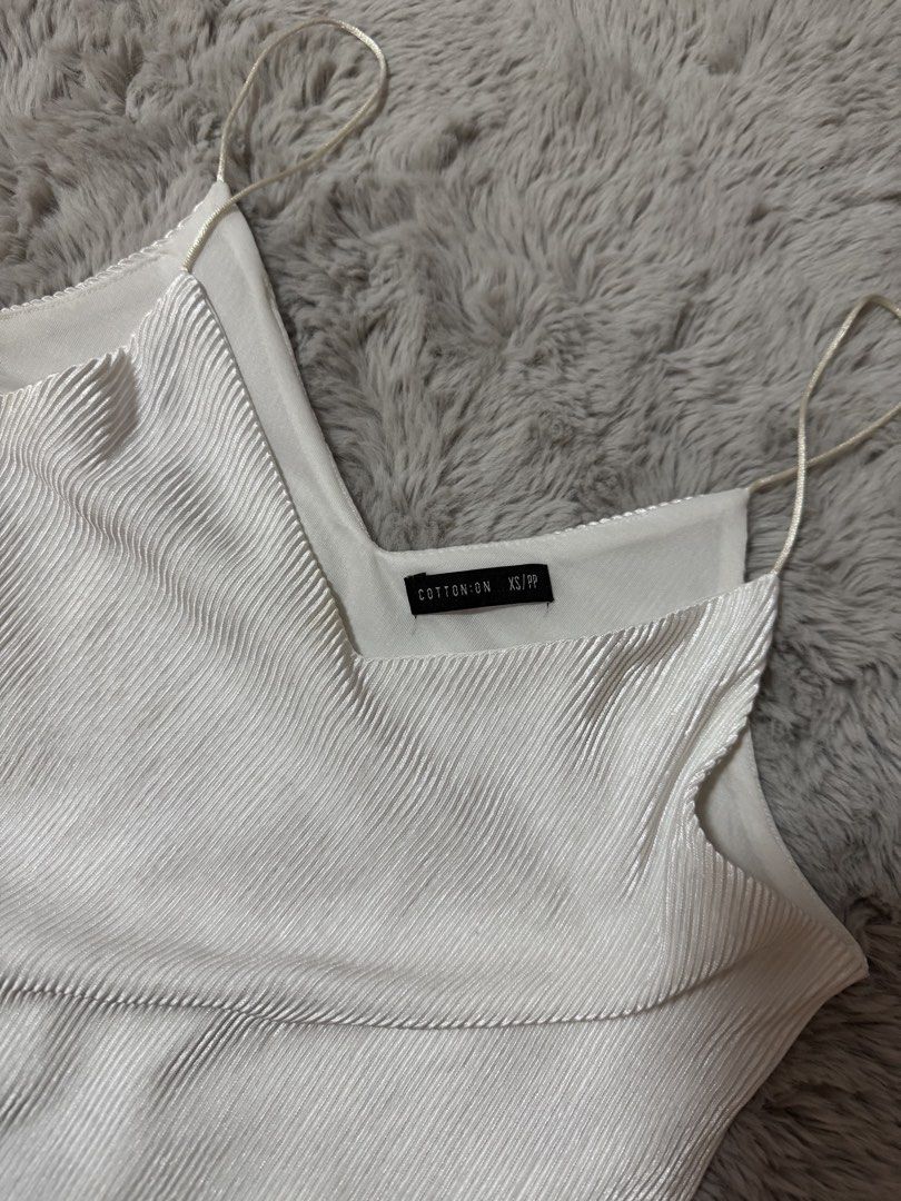 Cotton On White Pleated Cami Top (Category: Sleeveless) located in Calamba. Submitted by cheriiv (Listing ID 1469895791, Image 2). Description: - Brand: Cotton On - Size: XS - Color: White - Condition: Brand new with tags inside collar - Material/Design: All-over pleated texture with delicate spaghetti straps and V-neckline - Styling: Great basic piece for layering or wearing alone in warm weather.
