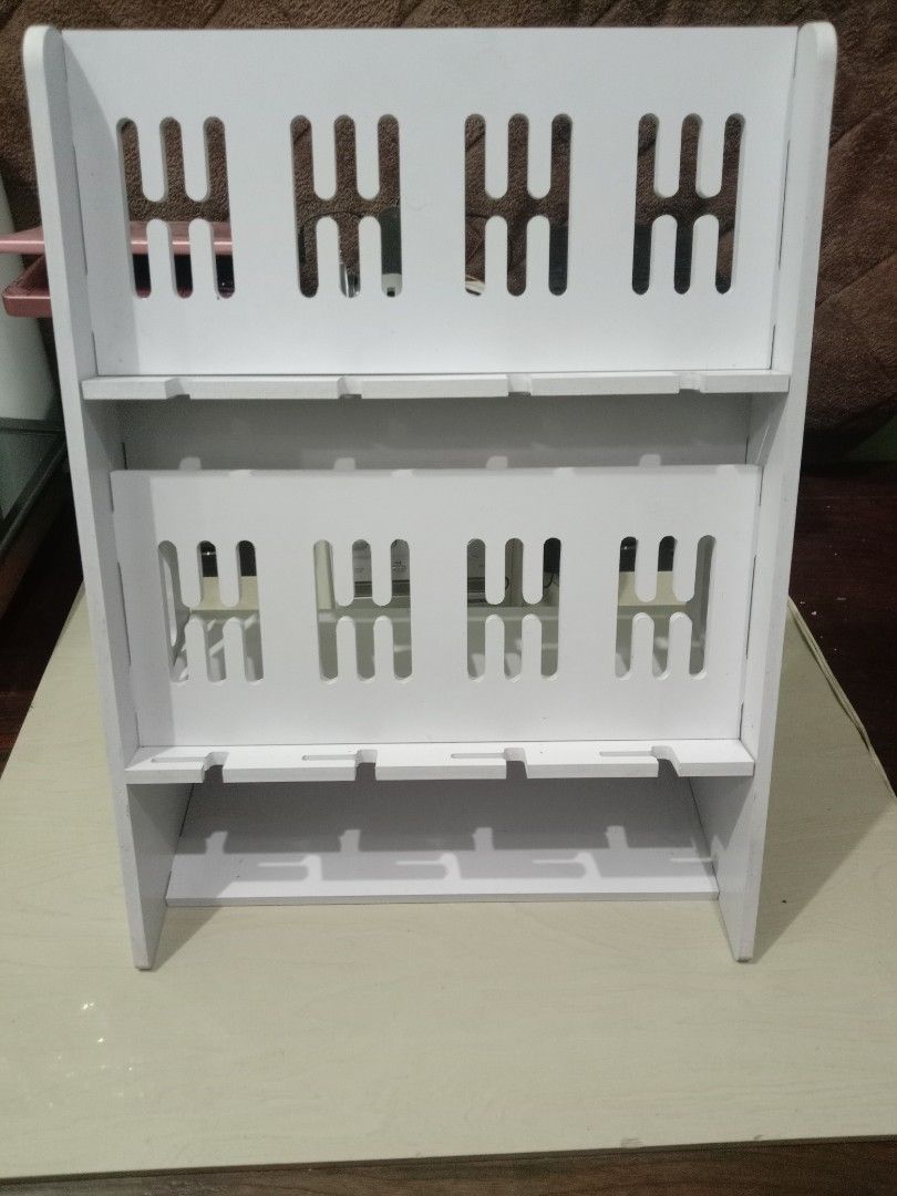 CP rack phone display stand multiple slots organizer white (Category: Mounts & Holders) located in Manila. Submitted by redvincent01640 (Listing ID 1469845465, Image 3). Description: - White multi-tier display rack for phones and tablets - Secure holding with slotted grooves on each shelf - Ideal for retail shops, repair stations, or home desk setups - Clean and minimalist design - 10 units available total (buy individually or get a bundle price)