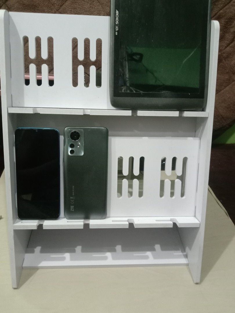 CP rack phone display stand multiple slots organizer white (Category: Mounts & Holders) located in Manila. Submitted by redvincent01640 (Listing ID 1469845465, Image 2). Description: - White multi-tier display rack for phones and tablets - Secure holding with slotted grooves on each shelf - Ideal for retail shops, repair stations, or home desk setups - Clean and minimalist design - 10 units available total (buy individually or get a bundle price)