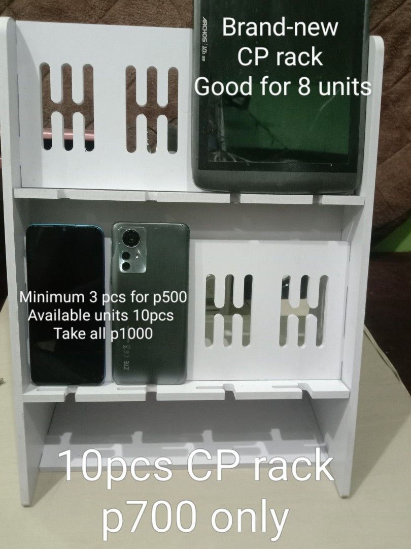 CP rack phone display stand multiple slots organizer white (Category: Mounts & Holders) located in Manila. Submitted by redvincent01640 (Listing ID 1469845465, Image 1). Description: - White multi-tier display rack for phones and tablets - Secure holding with slotted grooves on each shelf - Ideal for retail shops, repair stations, or home desk setups - Clean and minimalist design - 10 units available total (buy individually or get a bundle price)