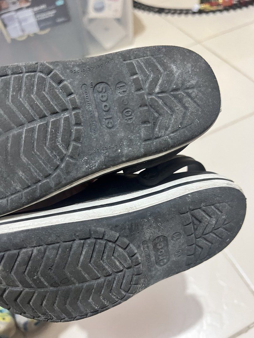 Crocs Black Clogs Shoes Size 10-11 (Category: Babies & Kids Fashion) located in Cavite. Submitted by nlp_preloved (Listing ID 1469910154, Image 3). Description: - Color: Classic black with white stripe and red logo button - Style: Slip-on with a secure back strap - Size: Marked as 10-11 (Made in Argentina) - Condition: Normal signs of wear on the bottom tread - Ideal for casual, everyday wear.