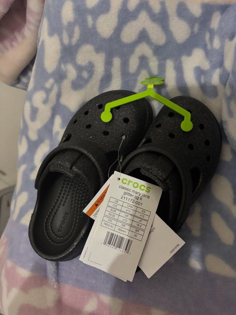 Crocs Classic Mary Jane Glitter Black C12 (Category: Babies & Kids Fashion) located in Manila. Submitted by viadinamama143 (Listing ID 1469809443, Image 1). Description: - Brand: Crocs Classic Mary Jane Glitter Clogs - Color: Black with sparkly finish - Size: Kids C12 / EUR 29-30 / UK C12 / JP 18.5 - Condition: Brand new with original tags and hanger attached - Features: Lightweight, easy slip-on style, and secure heel strap - Perfect for: Everyd