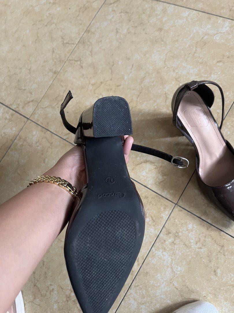 Cucoo Dark Brown Patent Pointed Toe Block Heels Size 37 (Category: Heels) located in Quezon City. Submitted by iamina16 (Listing ID 1469773819, Image 2). Description: - Color & Finish: Dark brown with a glossy patent finish - Size: 37 (printed on sole) - Design: Pointed toes and secure ankle straps - Heel: Stable chunky block heels for easy walking - Comfort: Cushion insoles with debossed logo branding - Condition: Minimal wear on the bottom sole