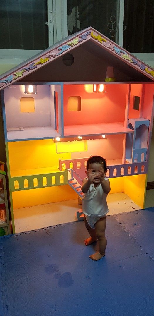 Customized Solid wood multi-story dollhouse with lights and furnitures (Category: Kids Toys) located in Binan City. Submitted by lesly.ly (Listing ID 1469908071, Image 2). Description: - Multi-story wooden dollhouse with sturdy construction and colorful painted details - Features working lights in the rooms, balconies, stairs, and a built-in closet on the top floor - Perfect gift for birthdays and special occasions *Note: This is really heavy and