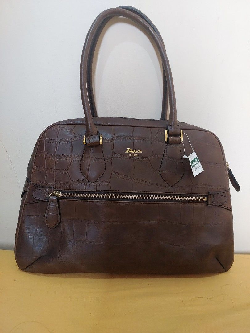Dakota Since 1969 Brown Crocodile Pattern Leather Handbag (Category: Luxury Bags & Wallets) located in Malabon City. Submitted by jullie_bag_shop (Listing ID 1469817645, Image 1). Description: - Brand: Dakota - Color: Dark Brown - Material: Embossed faux crocodile leather - Hardware: Gold-tone - Features: Double handle drop, secure zip-around closure, and front vertical zip pocket - Interior: Fabric-lined with multiple slip and zip pockets - Cond