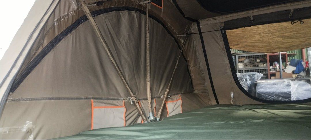 Darche rooftop tent (Category: Hiking & Camping) located in Marikina City. Submitted by studiogammo (Listing ID 1469861638, Image 3). Description: Darche intrepidor 2 RTT - Material: Heavy-duty khaki/brown canvas with orange trim and black contrast panels - Comfort: Built-in mattress and internal storage pockets - Hardware: Includes support poles and sturdy frame - Condition: LIGHTLY USED Ready for overlanding, road trips, and outdoor camping.