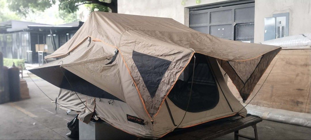 Darche rooftop tent (Category: Hiking & Camping) located in Marikina City. Submitted by studiogammo (Listing ID 1469861638, Image 2). Description: Darche intrepidor 2 RTT - Material: Heavy-duty khaki/brown canvas with orange trim and black contrast panels - Comfort: Built-in mattress and internal storage pockets - Hardware: Includes support poles and sturdy frame - Condition: LIGHTLY USED Ready for overlanding, road trips, and outdoor camping.