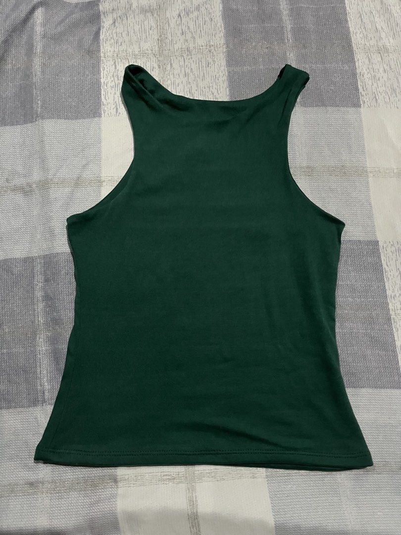 Dark Green Racerback Tank Top (Category: Sleeveless) located in Legazpi City. Submitted by chynnunez (Listing ID 1469877572, Image 1). Description: - Color: Dark green - Style: Racerback basic tank top with a high neckline and wide shoulder straps - Material: Soft and stretchy fabric for all-day comfort - Fit: Standard hip-length hem - Versatility: Minimalist solid design that pairs easily with jeans or shorts.