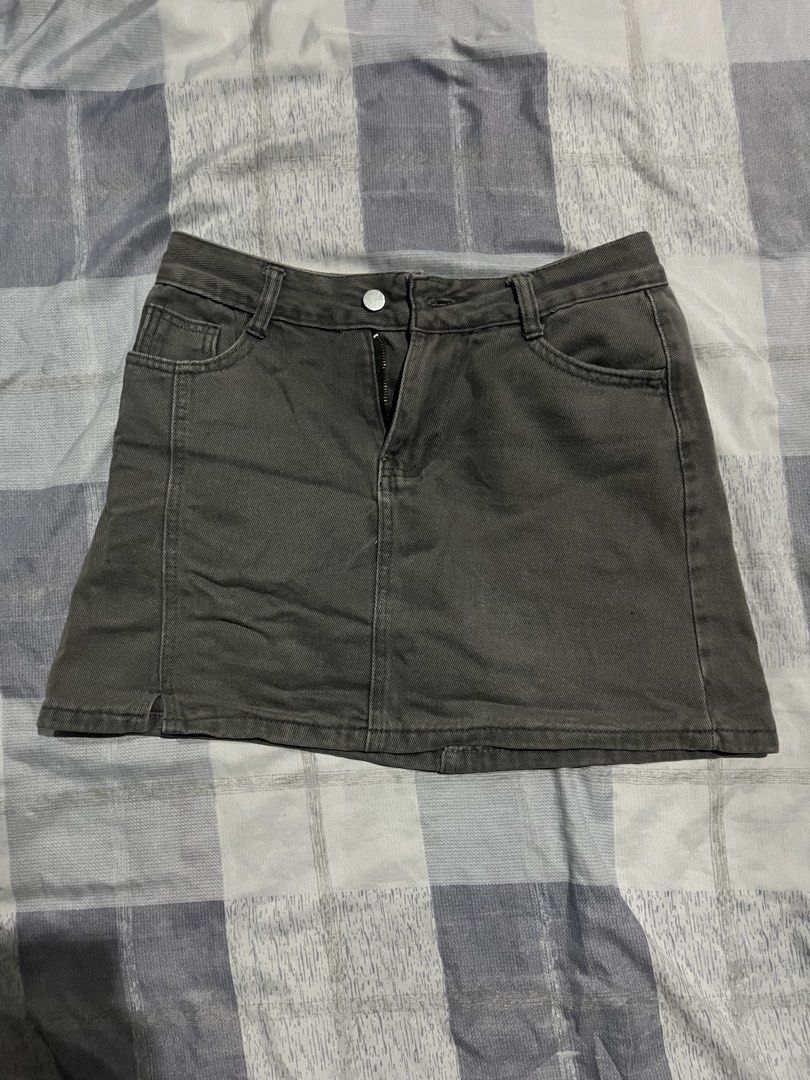 Dark Grey Denim Mini Skirt with Front Zip (Category: Skirts) located in Legazpi City. Submitted by chynnunez (Listing ID 1469876185, Image 1). Description: - Color: Dark grey - Style: Denim mini skirt with classic five-pocket design - Closure: Front button and zipper - Material: Structured cotton with slight stretch for comfort - Versatile: Easy to pair with casual tees or cozy sweaters - Condition: Excellent basic piece for everyday wear.