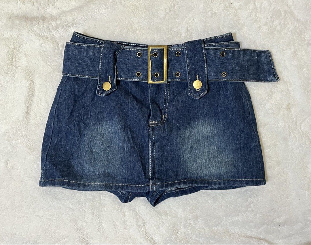 Dark wash denim kendall skort 💙 (Category: Skirts) located in Cagayan de Oro. Submitted by prelovedbynmei (Listing ID 1469833414, Image 1). Description: - Style: Dark wash denim skorts with faded front details - Closure & Accents: Built-in wide belt with gold buckle hardware and brass-tone grommets - Details: Two decorative button tabs on the waistband and stitched lines down the front center - Perfect for: Casual day outs and trendy OOTDs.