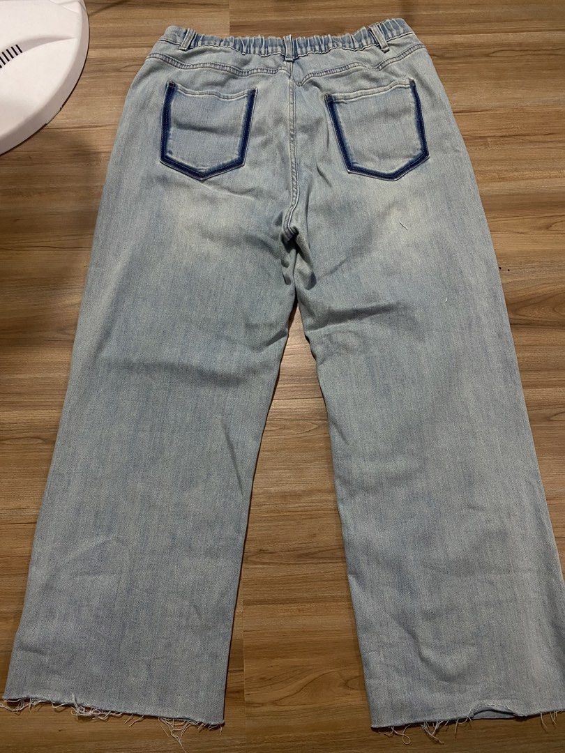 Denim 34" to 40" length 39" (Category: Jeans) located in Bulacan. Submitted by Spothings (Listing ID 1469884484, Image 2). Description: Light wash denim jeans with a wide leg fit. Elastic waistband at the back for extra stretch and comfort. Raw frayed hems at the bottom. Dark contrast stitching outlines the back pockets. Mid-rise style with front button and zipper closure. Light distressing and fading throughout. Great casual staple for everyday 