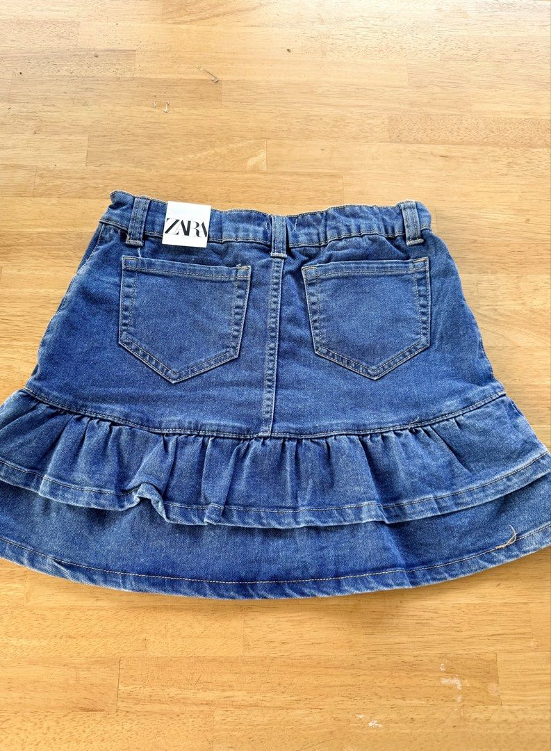 denim ruffle skort size 14 (Category: Skirts) located in Agdangan. Submitted by onahhhh (Listing ID 1469773458, Image 3). Description: - Brand: Zara - Size: 14 (with adjustable inner elastic waistband for custom fit) - Color: Classic blue denim - Style: Flared tiered skirt with double ruffle hem - Features: Five-pocket styling, belt loops, and front button closure - Condition: Great wardrobe staple, easy to pair with tees or sweaters.