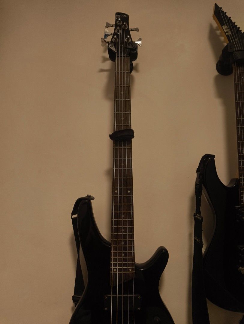 Deviser 5-string electric bass guitar black (Category: Musical Instruments) located in Rizal. Submitted by norkizz92 (Listing ID 1469860526, Image 1). Description: - Brand/Model: Deviser 5-string electric bass guitar - Finish: Gloss black body and matching headstock - Pickups & Hardware: Dual humbucking pickups with stylish silver hardware - Fretboard: Clean rosewood fretboard featuring classic dot inlays - Controls: Standard bridge and four body