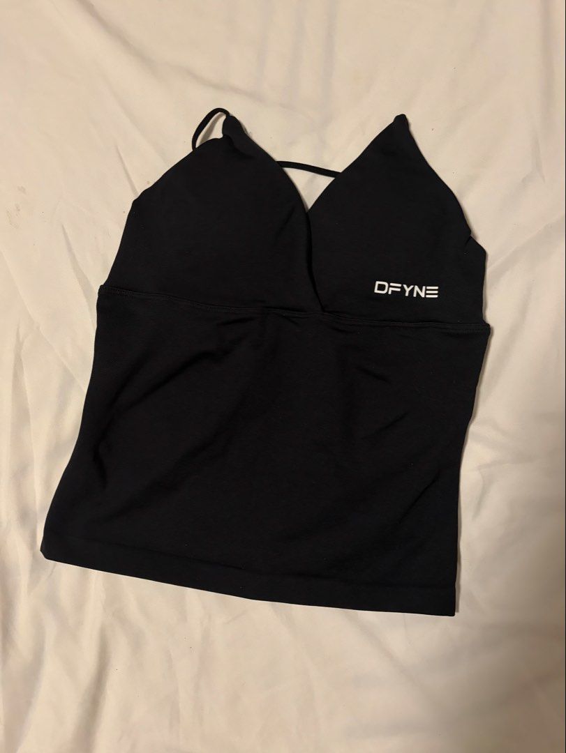 DFYNE BLACK VISION TWIST TOP (Category: Sleeveless) located in Manila. Submitted by rellasoli (Listing ID 1469876008, Image 1). Description: *Sleek black fitted activewear tank * Flattering V-neckline with thin straps * With padding * Stretchy, body-hugging material * DFYNE logo on front and back * Condition: Preloved OG Price: ₱3450 PLEASE READ🪽: * Please manage expectations as this is a preloved item. * Minor signs of wear may be present. * Co