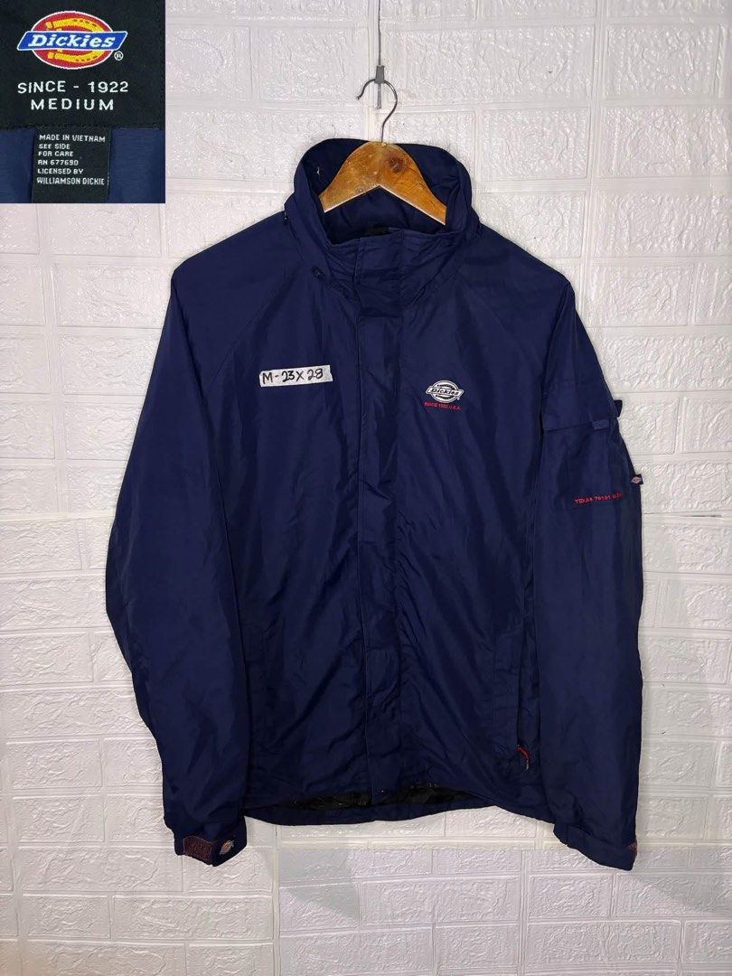 Dickies Navy Blue Windbreaker Jacket Medium (Category: Coats, Jackets and Outerwear) located in Davao. Submitted by ruggedthrift444 (Listing ID 1469859673, Image 1). Description: - Brand: Dickies - Color: Navy Blue - Size: Medium (23 inches pit-to-pit x 28 inches length) - Design: Stand collar, front zip closure with snap storm flap - Details: Embroidered chest logo and utility sleeve pocket on the left arm - Fit: Lightweight outer layer, ideal f