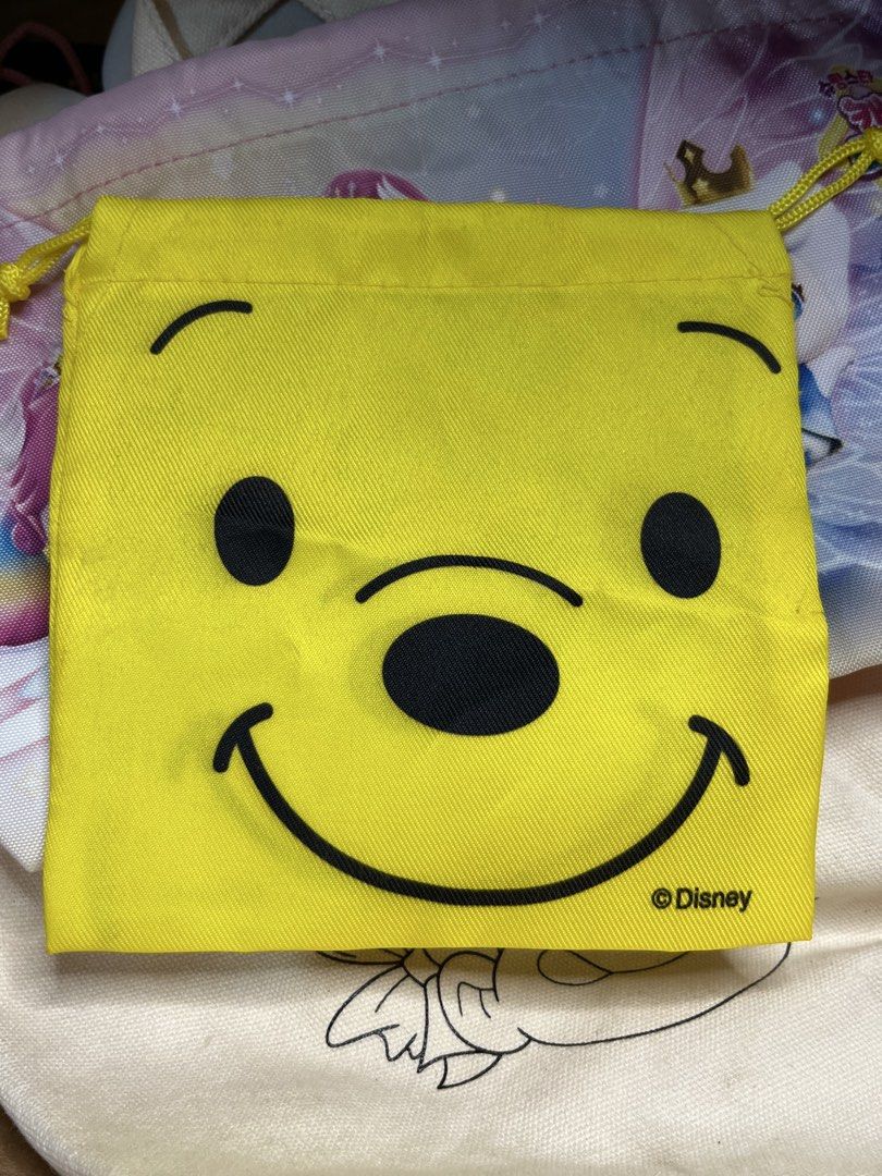 Disney Winnie the Pooh Yellow Drawstring Pouch (Category: Purses & Pouches) located in Gapan. Submitted by lunashop14 (Listing ID 1469836079, Image 1). Description: - Authentic Disney Winnie the Pooh merchandise - Vibrant yellow drawstring pouch with cute character graphics - Clean interior lining for safe storage - Handy size for organizing cosmetics, coins, or daily trinkets - Perfect for tossing into your everyday tote.