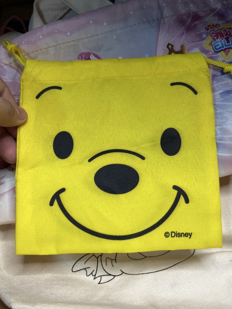 Disney Winnie the Pooh Yellow Drawstring Pouch (Category: Purses & Pouches) located in Gapan. Submitted by lunashop14 (Listing ID 1469836079, Image 3). Description: - Authentic Disney Winnie the Pooh merchandise - Vibrant yellow drawstring pouch with cute character graphics - Clean interior lining for safe storage - Handy size for organizing cosmetics, coins, or daily trinkets - Perfect for tossing into your everyday tote.