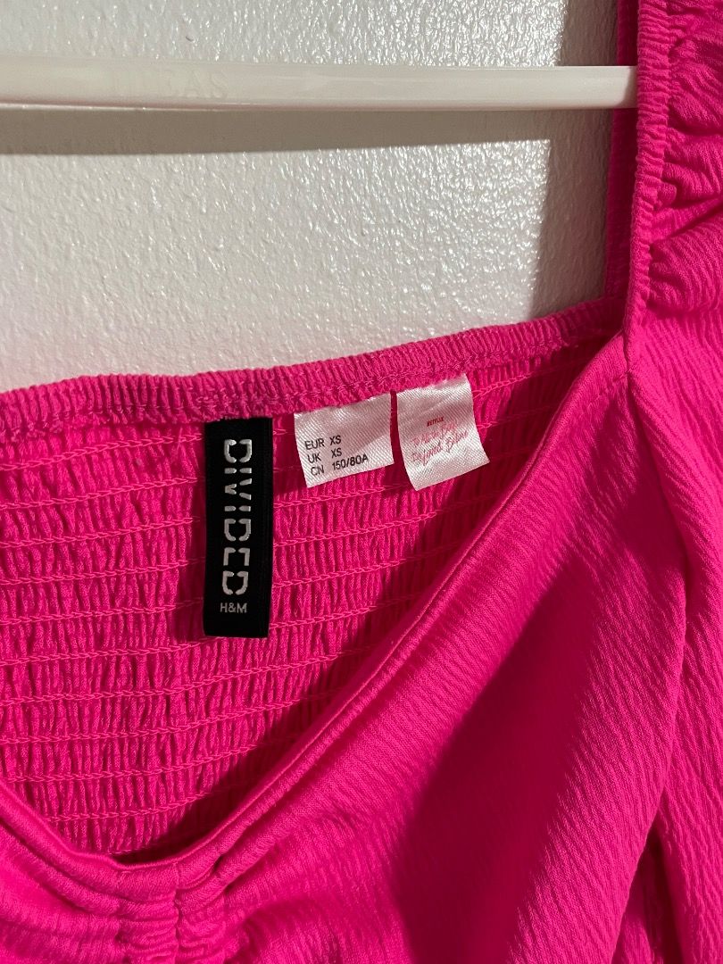 Divided by H&M Hot Pink Crop Top (Category: Shirts) located in Cabuyao City. Submitted by rdtrmt (Listing ID 1469875577, Image 3). Description: - Brand: Divided by H&M - Size: XS - Color: Bright hot pink - Details: Square neckline, long sleeves, smocked bodice, and center front ruching with adjustable drawstring ties - Fabric: Textured crinkle material - Condition: Worn once, still in good condition.