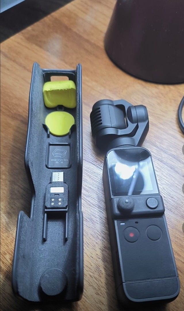 DJI Osmo Pocket 2 Creator Combo Gimbal Camera (Category: Video Cameras) located in Caloocan City. Submitted by afkafk088 (Listing ID 1469930594, Image 2). Description: - DJI Osmo Pocket 2 handheld camera with motorized gimbal - 256gb memory card - Includes protective case with slots for smartphone adapter and wide-angle lens - Fully functional with minor handling wear .