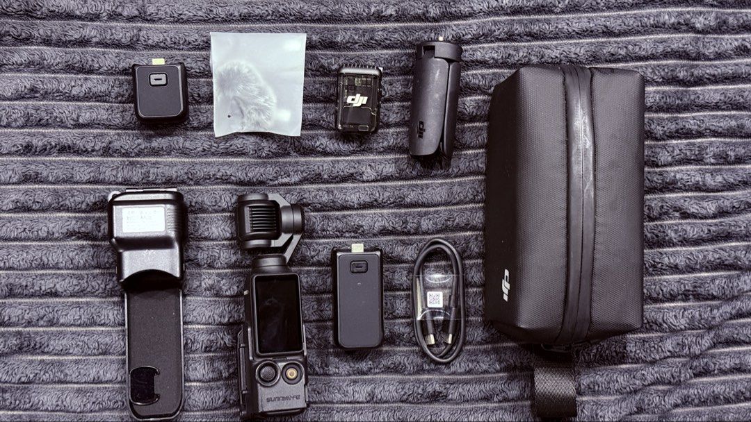 DJI Osmo Pocket 3 creators combo with Accessories (Category: Video Cameras) located in Mandaluyong City. Submitted by jayr18_ (Listing ID 1469765752, Image 1). Description: - DJI Osmo Pocket camera setup in sleek black - Tested and 100% working properly - Includes main gimbal unit in protective case - Extension module grip handle and mini tripod included - DJI Mic transmitter unit with deadcat wind muff - USB-C charging cable and custom zippered 