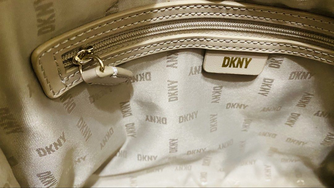 DKNY shoulder/satchel bag (Category: Shoulder Bags) located in Bulacan. Submitted by majo0425 (Listing ID 1469792467, Image 3). Description: white and beige monogram-patterned DKNY shoulder/satchel bag featuring gold-tone chain handles and a detachable crossbody strap..