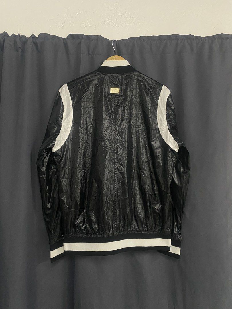 Dolce & Gabbana Black White Bomber Jacket Size 54 (Category: Coats, Jackets and Outerwear) located in Santa Maria. Submitted by saintarchive316 (Listing ID 1469942805, Image 2). Description: -Length: 27 -Width: 23 - Authentic Dolce & Gabbana bomber jacket - Color: Black with white contrast panels - Size: 54 (Made in Italy) - Material: Glossy finish with full zip front - Details: Ribbed collar, cuffs, and hem, functional side zip pockets - Brandin