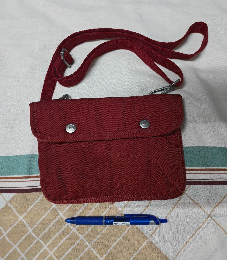 Doughnut Red Crossbody Shoulder Bag (Category: Cross-body Bags) located in Pasig City. Submitted by she_declutters_ph (Listing ID 1469917146, Image 1). Description: - Brand: Doughnut - Size: 8.5 x 6 inches Compact and lightweight, ideal for carrying your daily essentials Used this as an airport bag. - Color: Vibrant Red - Material: Durable canvas with stylish silver metal hardware - Closure: Secure snap-button flap and zippered main compartment -