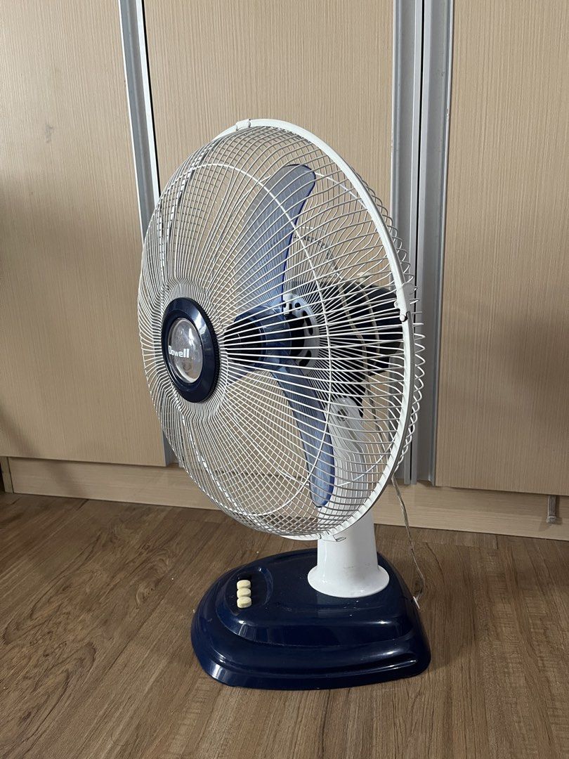 Dowell desk fan blue and white (Category: Fans) located in Taguig. Submitted by albm.business (Listing ID 1469920707, Image 2). Description: - Brand: Dowell - Color: Dark blue and white - Blades: 3 translucent blue blades - Controls: 3 speed buttons with separate off switch - Plug: Standard two-prong plug with long white cord - Condition: needs fixing. di po umiikoy pag sinaksak.