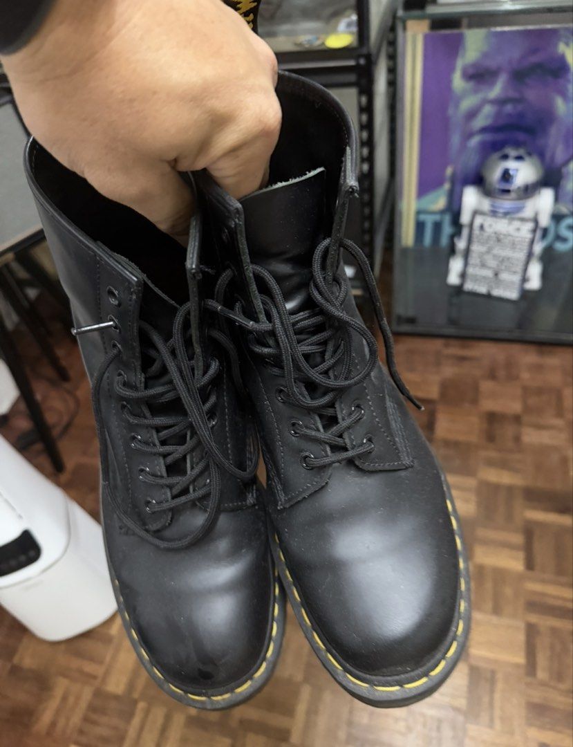 Dr. Martens 1460 Black Leather Boots size 12 (Category: Boots) located in Marikina City. Submitted by rexie5 (Listing ID 1469813097, Image 2). Description: - Brand: Dr. Martens - Style: Classic 8-eyelet lace-up boots - Color: Black - Features: Signature yellow welt stitching, translucent air-cushioned rubber soles with great grip - Condition: Natural creasing on uppers and slight scuffs on the toe area from regular wear - Durability: Sturdy build