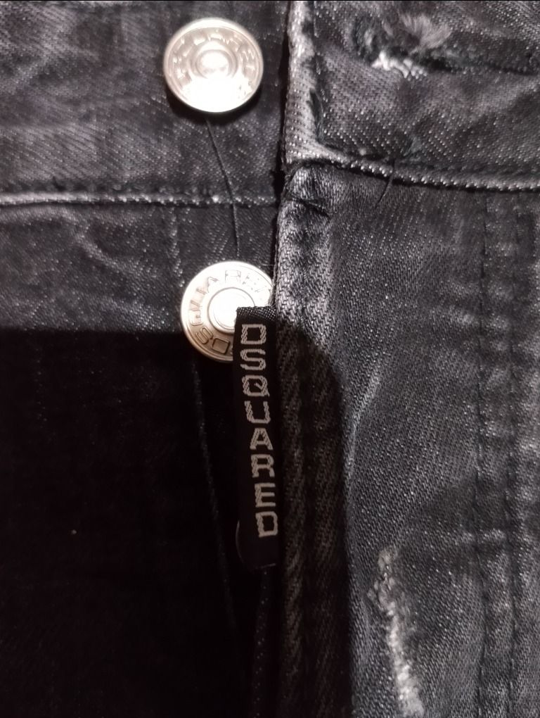 Dsquared2 Black Distressed Denim Jeans (Category: Jeans) located in Cavite. Submitted by marvzclothing (Listing ID 1469892061, Image 3). Description: - Brand: Dsquared2 by Dean and Dan - Waist: 30 - Color: Black dark wash - Style: Moto-paneled straight leg with heavy distressing, whiskering, and ripped knees - Closure: Button fly with branded hardware and logo tab - Details: Leather branding patch on the back pocket, rolled cuffs showing grey int