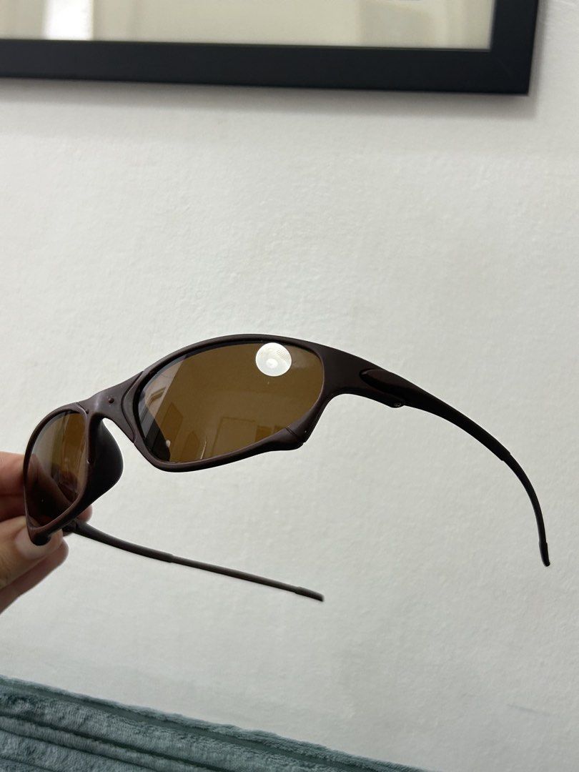 Dupe Oakley Juliet Sunglasses Brown (Category: Sunglasses & Eyewear) located in Cavite. Submitted by _schmyla (Listing ID 1469885578, Image 3). Description: - Brand/Model: Oakley sunglasses - Color: Dark brown frame with tinted brown lenses - Design: Sporty wrap-around frame, lightweight build - Condition: Clean lenses, no major scratches - Best for: Daily wear, driving, or outdoor sports.
