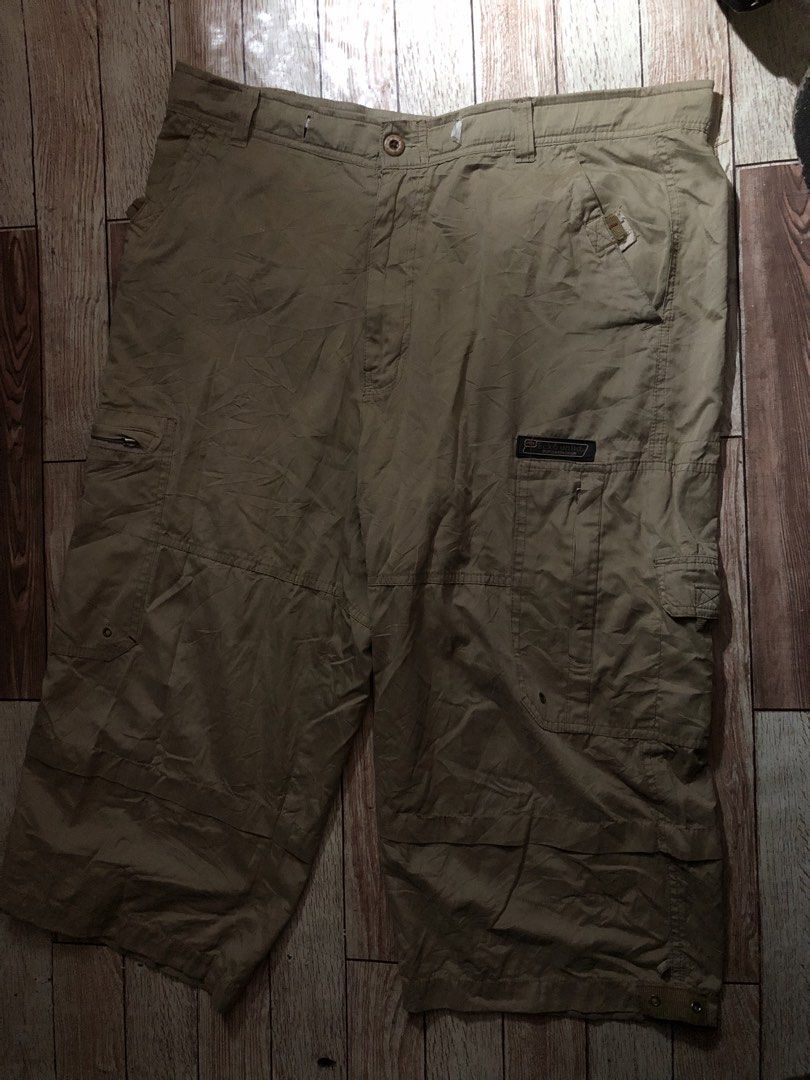 Eckō Unltd. Cargo Shorts Khaki (Category: Shorts) located in Manila. Submitted by fleis.it (Listing ID 1469876878, Image 1). Description: - Brand: Eckō Unltd. - Color: Khaki - Material: Heavy-duty cotton - Fit: Loose, relaxed fit through the legs - Features: Multiple side and back pockets, zipped fly, branded button closure - Details: Woven logo patches on front and back pockets - Condition: Noticeable wear near the waistband check pic for issues