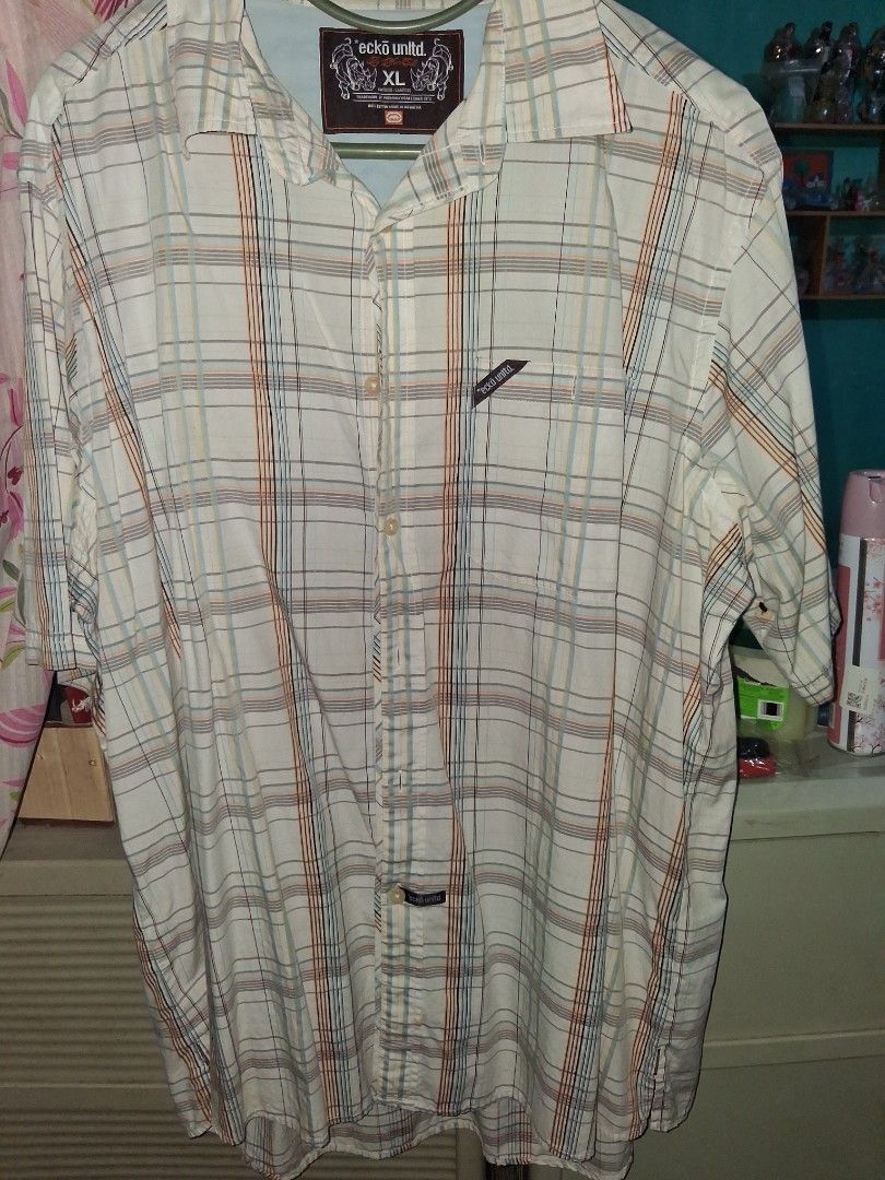 Vintage Ecko Unltd. Plaid Button Down Shirt Size XL (Category: Tshirts & Polo Shirts ) located in Manila. Submitted by youngmetro323 (Listing ID 1469799363, Image 1). Description: - Brand: Eckō Unltd. - Style: Button-down shirt with cream, orange, blue, and black plaid pattern - Size: XL - Material: 100% cotton (Made in Indonesia) - Details: Front chest pocket with brand tag, logo patch on back collar - Extras: Spare buttons included inside - Con