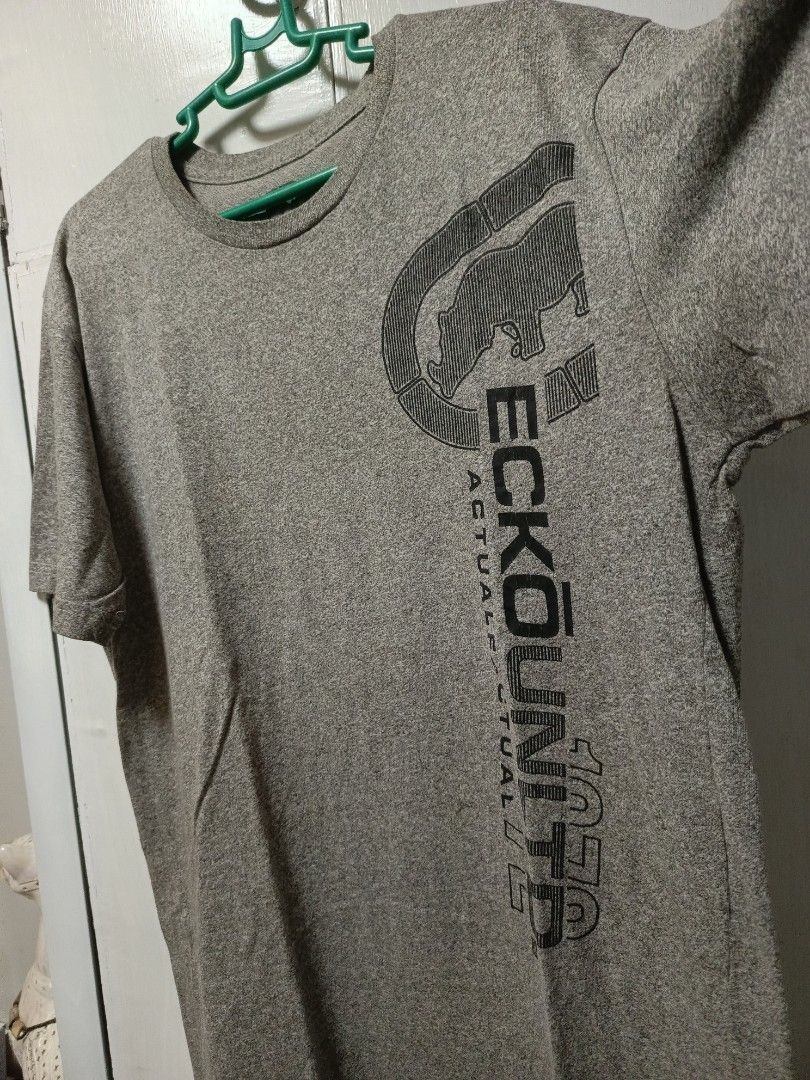 Ecko Unltd Heather Grey Graphic Tee (Category: Tshirts & Polo Shirts ) located in Cabatuan. Submitted by penthegreat (Listing ID 1469784186, Image 3). Description: 22.5x29.5 issue: minimal cracked prints - Brand: Ecko Unltd - Color: Heather Grey - Material: Soft Cotton - Fit: Regular - Design: Large vertical black rhino logo with 'ECKO UNLTD' and 'ACTUAL FACTUAL 1972' text.