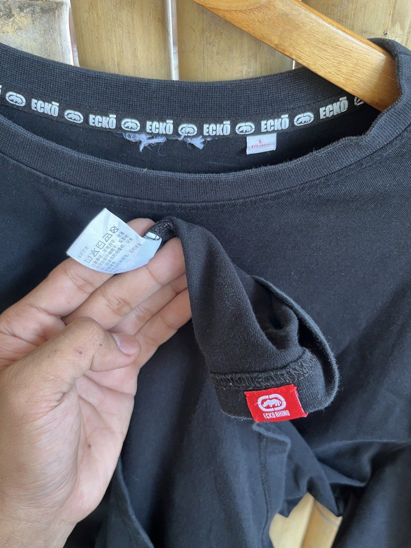 Ecko Unltd Racing Black T-Shirt Size L (Category: Tshirts & Polo Shirts ) located in Manila. Submitted by thrifttika (Listing ID 1469828811, Image 3). Description: - Brand/Model: Ecko Unltd Racing Black T-Shirt - Size: L (fits true to size) - Material: Soft and comfortable cotton - Design: Small white chest logo and bold race track graphic on the back - Details: Branded neck tape and iconic red rhino tag on the bottom hem - Style: Perfect additio