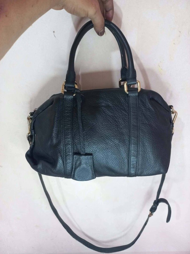 Emini House black leather handbag with strap (Category: Luxury Bags & Wallets) located in Manila. Submitted by dei03_diz (Listing ID 1469778683, Image 1). Description: - Brand: Emini House - Color & Material: Black textured leather with gold-tone hardware - Closure: Secure zip-top closure - Carrying Options: Double top handles and an adjustable, detachable shoulder strap - Interior: Signature branded fabric lining with a convenient zip pocket - D