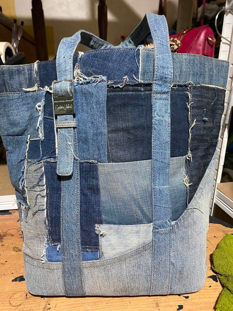 Emotional World Vintage Denim Patchwork Tote Bag (Category: Tote Bags) located in Lapu Lapu. Submitted by ukaydecebuofficial (Listing ID 1469792013, Image 2). Description: - Brand: Emotional World - Style: Denim patchwork tote bag with an upcycled look and frayed edges - Design: Varied wash shades with metallic buckle hardware on the front - Handles: Two sturdy top handles - Interior: Deep blue lining with brand patch logo - Storage: Convenient z