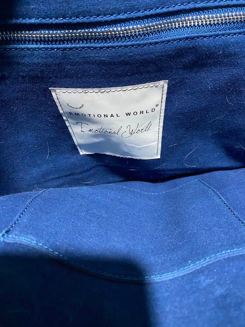 Emotional World Vintage Denim Patchwork Tote Bag (Category: Tote Bags) located in Lapu Lapu. Submitted by ukaydecebuofficial (Listing ID 1469792013, Image 3). Description: - Brand: Emotional World - Style: Denim patchwork tote bag with an upcycled look and frayed edges - Design: Varied wash shades with metallic buckle hardware on the front - Handles: Two sturdy top handles - Interior: Deep blue lining with brand patch logo - Storage: Convenient z