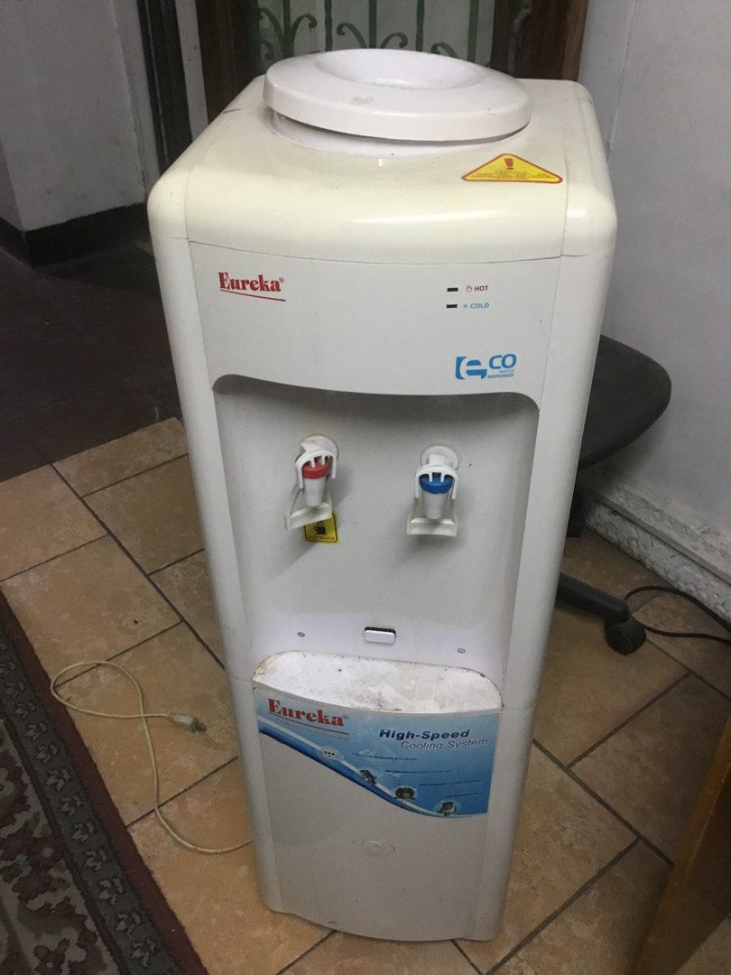 Eureka Eco Water Dispenser High-Speed Cooling System (Category: Water Purifiers & Dispensers) located in Manila. Submitted by roberto.enriquez (Listing ID 1469818721, Image 1). Description: - Brand: Eureka Standing Water Dispenser - Color: Clean White Body - Taps: Red for Hot water, Blue for Cold water - Design: Standard top-loading for water jugs - Performance: Equipped with a high-speed cooling system - Condition: Pre-owned with minor dust and 