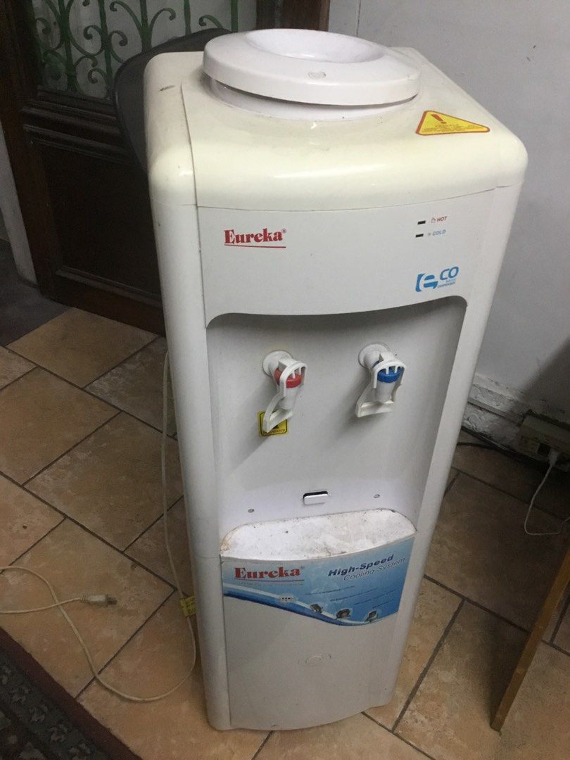 Eureka Eco Water Dispenser High-Speed Cooling System (Category: Water Purifiers & Dispensers) located in Manila. Submitted by roberto.enriquez (Listing ID 1469818721, Image 2). Description: - Brand: Eureka Standing Water Dispenser - Color: Clean White Body - Taps: Red for Hot water, Blue for Cold water - Design: Standard top-loading for water jugs - Performance: Equipped with a high-speed cooling system - Condition: Pre-owned with minor dust and 