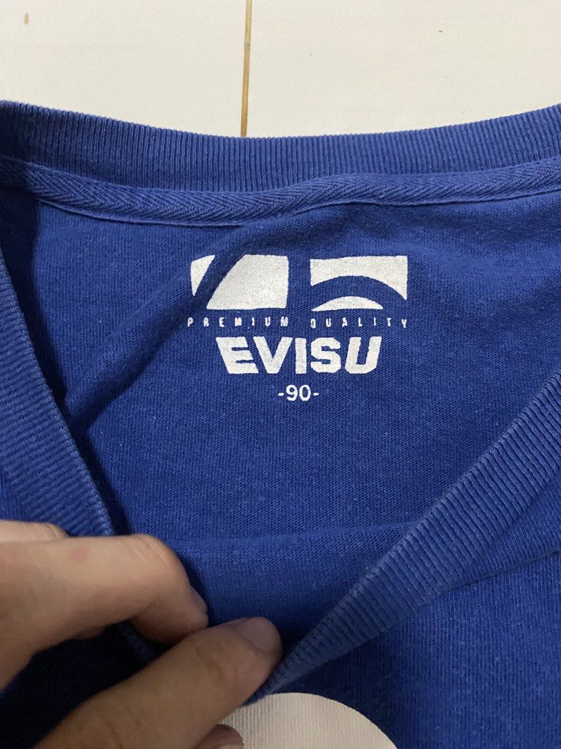 Evisu Blue T-Shirt (Category: Tshirts & Polo Shirts ) located in Manila. Submitted by morsgotthrift (Listing ID 1469796030, Image 3). Description: - Authentic Evisu short sleeve tee in royal blue - Large white seagull logo on the chest with a small logo hit on the upper back - Tagged size 90 - Made from soft cotton fabric with a comfortable ribbed crew neckline - Clean and stylish piece for casual streetwear looks.
