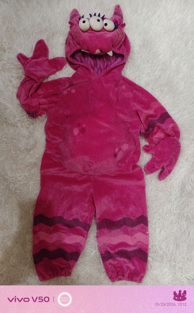 EZEFINDS Pink Monster Costume with Hood (Category: Babies & Kids Fashion) located in Cainta. Submitted by Ezefinds (Listing ID 1469801849, Image 1). Description: -EZEFINDS Pink Monster Costume with Hood -Preloved Needs Wash -24mos on tag fit 18mos to 2yo - Vibrant bright pink monster costume made from super soft plush material - Hood comes with 3 playful eyes, purple spikes, and cute teeth details - Includes convenient attached hand covers - Feat