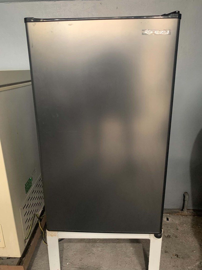 EZY Refrigerator Model ES-99Ra Mini Fridge (Category: Refrigerators and Freezers) located in Manila. Submitted by dragonlady118 (Listing ID 1469830176, Image 1). Description: - Brand: EZY - Model: ES-99Ra - Exterior Finish: Sleek black with a sturdy white frame base - Width: 18.8 inches (compact design, ideal for small spaces) - Power: 220-240V, 60Hz - Interior Features: Clean white compartments, adjustable glass shelves, crisper drawer, and door