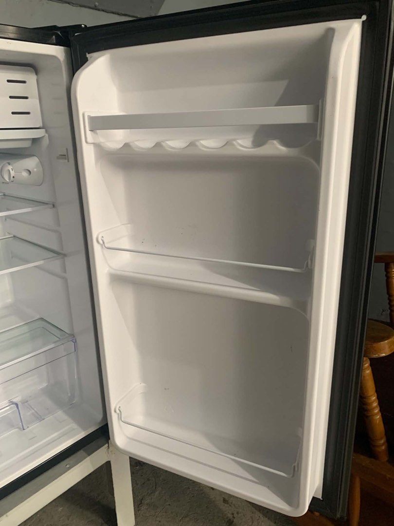 EZY Refrigerator Model ES-99Ra Mini Fridge (Category: Refrigerators and Freezers) located in Manila. Submitted by dragonlady118 (Listing ID 1469830176, Image 3). Description: - Brand: EZY - Model: ES-99Ra - Exterior Finish: Sleek black with a sturdy white frame base - Width: 18.8 inches (compact design, ideal for small spaces) - Power: 220-240V, 60Hz - Interior Features: Clean white compartments, adjustable glass shelves, crisper drawer, and door