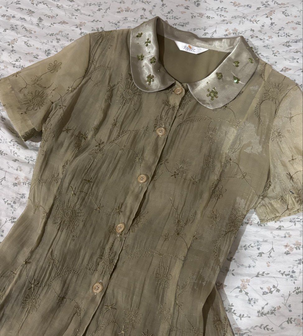 Fairy Grunge y2k Blouse (Category: Blouses) located in Davao. Submitted by dvnzaii (Listing ID 1469876438, Image 2). Description: - Brand: Rabbit - Style: Short sleeve button-down blouse (Y2K / Fairy Grunge) - Fabric: All-over floral embroidery - Details: Smooth satin collar with green beaded and sequin embellishments - Fit: Structured torso with a slightly flared hem - Closure: Front button-up.