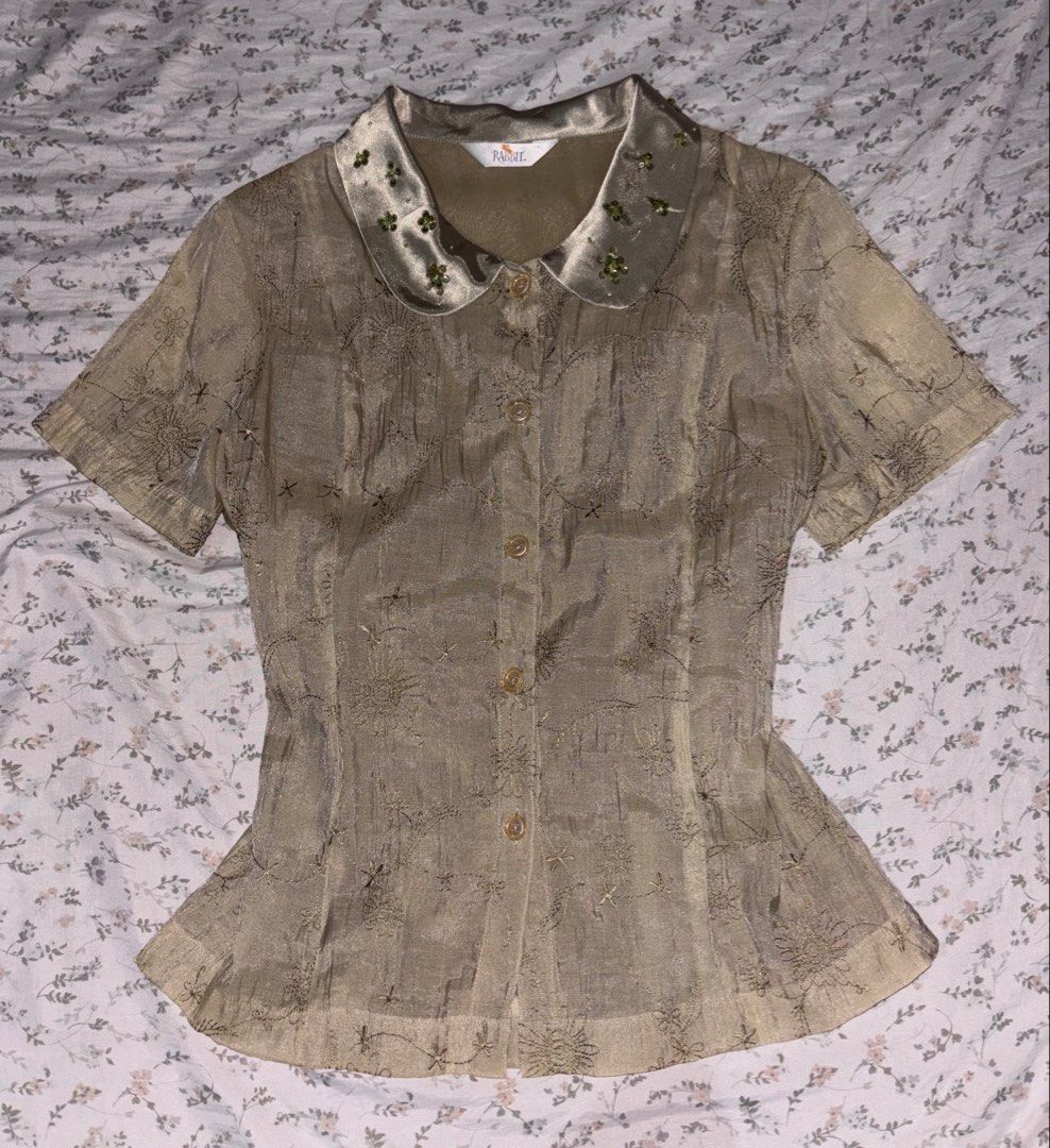 Fairy Grunge y2k Blouse (Category: Blouses) located in Davao. Submitted by dvnzaii (Listing ID 1469876438, Image 1). Description: - Brand: Rabbit - Style: Short sleeve button-down blouse (Y2K / Fairy Grunge) - Fabric: All-over floral embroidery - Details: Smooth satin collar with green beaded and sequin embellishments - Fit: Structured torso with a slightly flared hem - Closure: Front button-up.