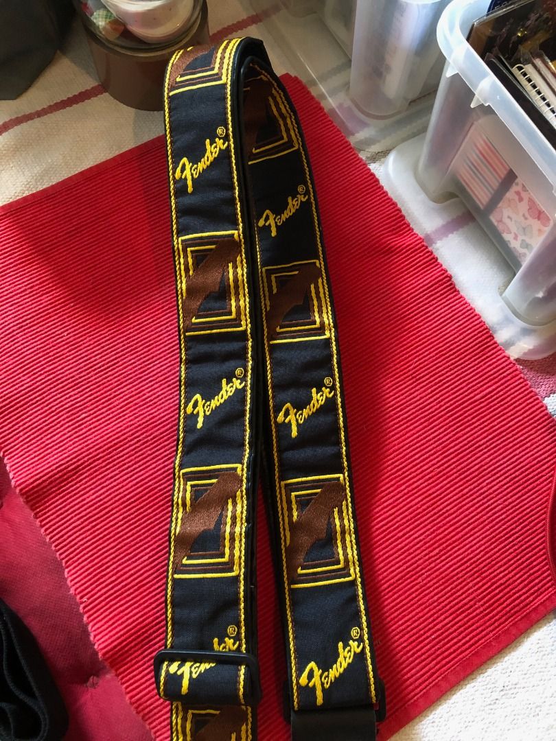 Fender Guitar Strap Black Yellow Brown (Category: Musical Instruments) located in Calamba. Submitted by marjoh29436 (Listing ID 1469856116, Image 3). Description: An Authentic Fender guitar strap / Stylish black background with embroidered logos and geometric patterns / Eye-catching yellow script and brown box details / Adjustable plastic buckle for a custom fit / Durable leather ends with standard peg holes / Clean fabric and solid stitching thr