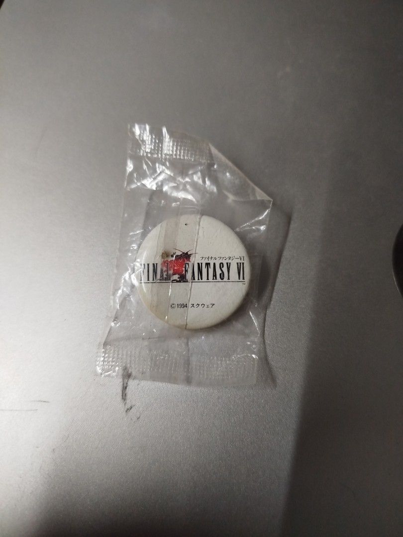 Final Fantasy VI 1994 Square Pin Badge (Category: Vintage Collectibles) located in Binan City. Submitted by pumpkiiin02 (Listing ID 1469916791, Image 1). Description: - Authentic 1994 Square Final Fantasy VI collectible pin - Features the iconic classic red logo design - Format: Small round lapel pin - A must-have rare vintage piece for JRPG fans and collectors Condition: - Slightly opened seal at the back - With visible yellow stains (at the low