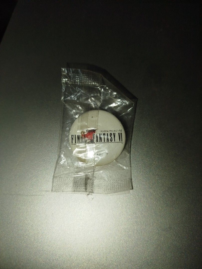 Final Fantasy VI 1994 Square Pin Badge (Category: Vintage Collectibles) located in Binan City. Submitted by pumpkiiin02 (Listing ID 1469916791, Image 2). Description: - Authentic 1994 Square Final Fantasy VI collectible pin - Features the iconic classic red logo design - Format: Small round lapel pin - A must-have rare vintage piece for JRPG fans and collectors Condition: - Slightly opened seal at the back - With visible yellow stains (at the low